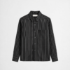 Black vertical stripe overshirt with oversized fit and modern layered streetwear styling by DAHAR.